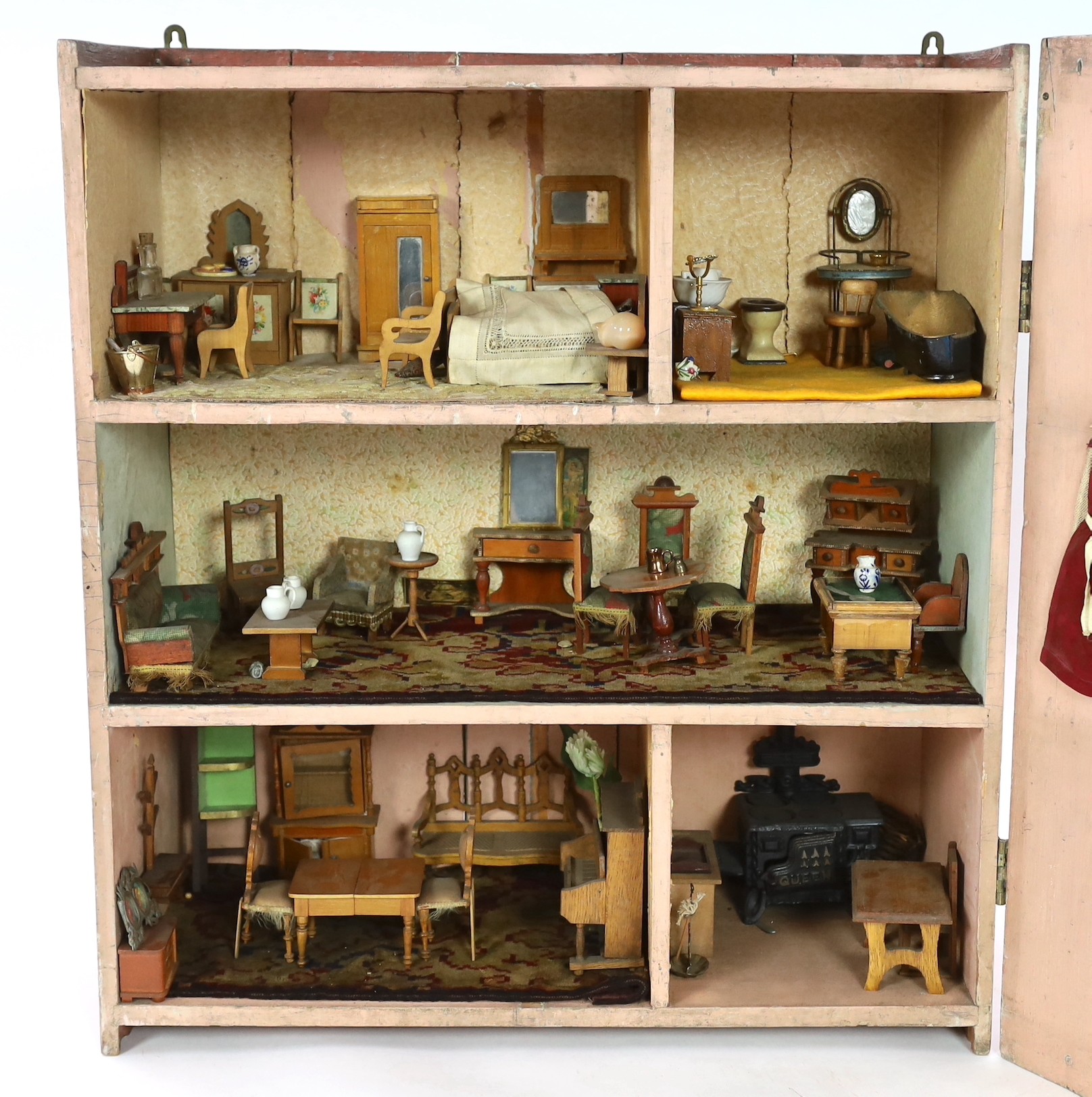 A Victorian furnished dolls’ house, circa 1890, 77cm high.